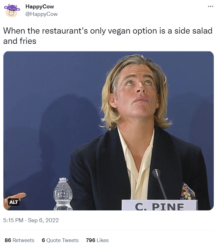 A tweet from HappyCow. It reads "When the restaurant's only vegan option is a side salad and fries" and includes a viral photo of Chris Pine looking up as if his patience is being tested.